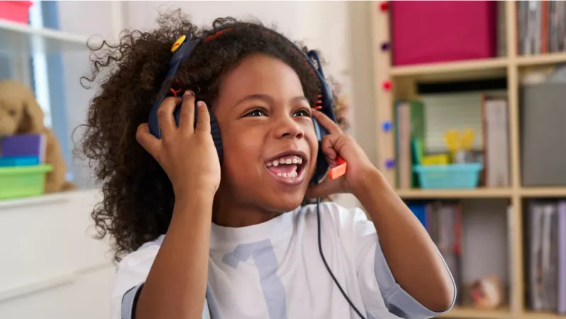 Child listening to a lesson on her Logitech Zone Learn Wired headset